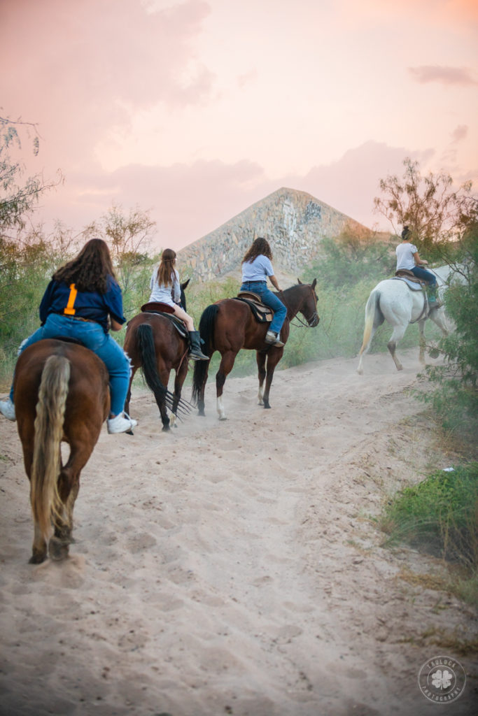 A sunset trail ride for camp at a horseback riding stable in El Paso, Texas.