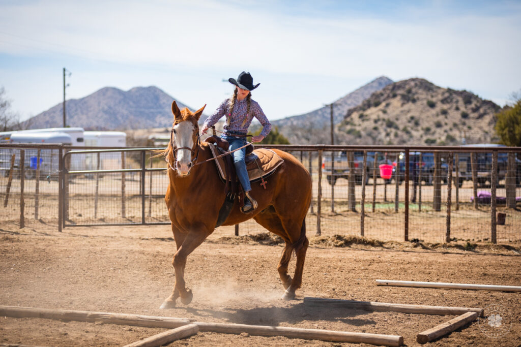 Photo of a cowgirl riding a horse over a trail pattern in the arena in El Paso, Texas. 